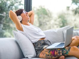 Woman listening to music on laptop