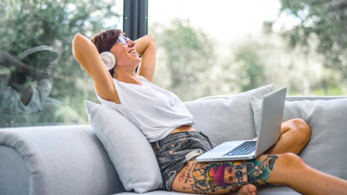 Woman listening to music on laptop