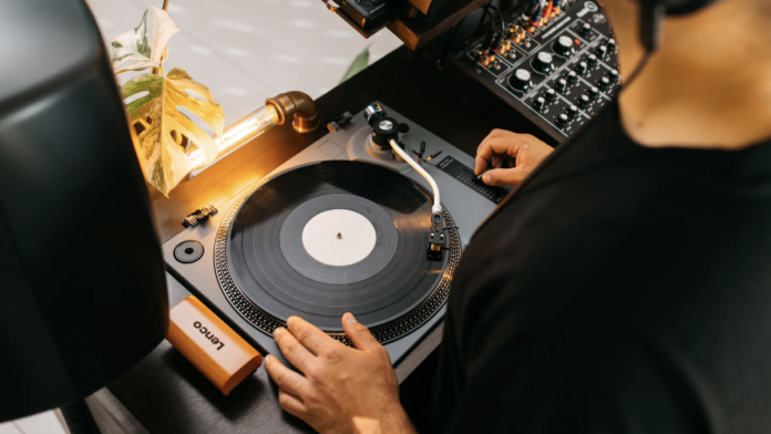 Someone putting a record onto the Lenco L-3810 turntable