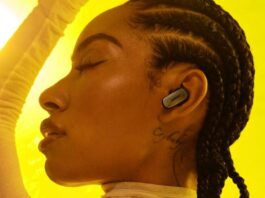 A woman in yellow wearing Bose QuietComfort Ultra Earbuds