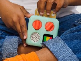 A kid holds the Yoto Mini speaker